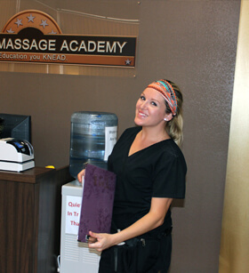 Student smiling at camera in massage school in Brownwood and Abilene Texas during her clinical.