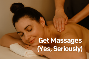 A woman lies face down on a massage table, smiling softly with eyes closed as a therapist massages her upper back. Overlaid white text reads “Get Massages (Yes, Seriously).”